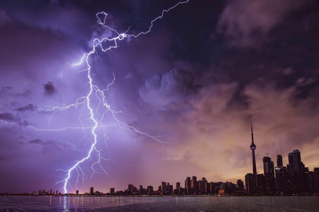 lightning-and-gray-clouds-1162251 A striking lightning bolt illuminates the Toronto skyline against a dramatic stormy sky.